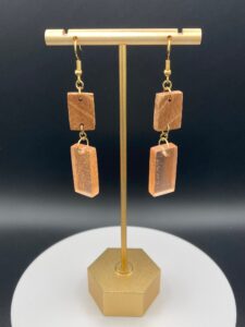 orange dangle earrings on pedestal